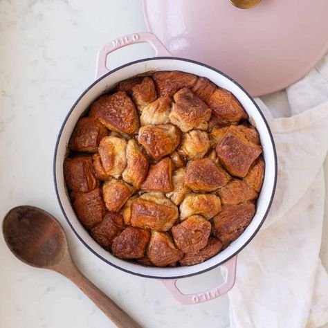 Made with canned biscuit dough, a butter brown sugar sauce, and cinnamon sugar, this pull-apart Dutch Oven Monkey Bread is an easy breakfast. Monkey Bread Dutch Oven, Dutch Oven Monkey Bread, Monkey Bread With Canned Biscuits Easy, Monkey Bread Breakfast, Monkey Bread With Canned Biscuits, Dutch Oven Breakfast, Biscuit Monkey Bread, Brown Sugar Sauce, Dutch Oven Camping Recipes