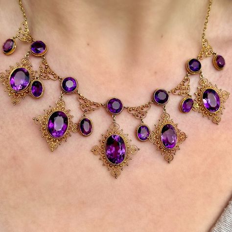 Happy National Antiques Day! Behold, the amethyst necklace of dreams!💜✨ A majestic antique Victorian necklace featuring a fabulous gallery consisting of eleven droppers and sixteen deep purple amethysts that range from approx. 0.80ct to 6ct (approx. 32ct total). Each stone is bezel set with a rope edge and surrounded by beautiful, scrolling cannetille metalwork all fashioned in 18ct gold. The piece dates to the late 19th Century and is in excellent condition. A glamorous and regal statement... Magnificent Century Jewelry, Victorian Jewelry Necklace, Antique Necklace Victorian, Ornate Necklace, British Crown Jewels, Baroque Jewelry, Colourful Jewellery, Victorian Jewellery, Edwardian Engagement Ring