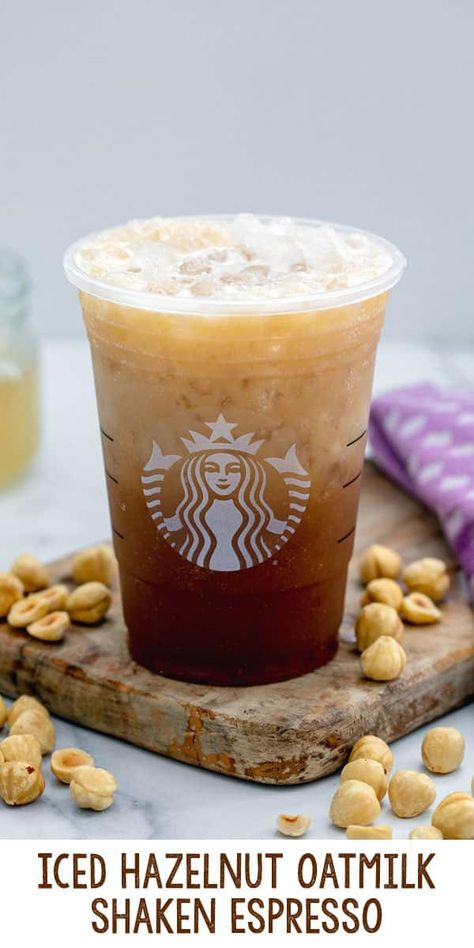 Iced Hazelnut Oatmilk Shaken Espresso {Starbucks Copycat} -- It's nutty season at Starbucks and we're all here for the new Iced Hazelnut Oatmilk Shaken Espresso! My copycat recipe for this hazelnut iced drink is so easy to make and customize at home with just a few ingedients. via @wearenotmartha Starbucks Hazelnut Drinks, Iced Hazelnut Oatmilk Shaken Espresso, Hazelnut Oatmilk Shaken Espresso, Iced Oatmilk Shaken Espresso, Hazelnut Syrup Recipe, Hazelnut Oat Milk Shaken Espresso, Oat Shaken Espresso Starbucks, Hazelnut Shaken Espresso Starbucks, Starbucks Hazelnut Iced Coffee