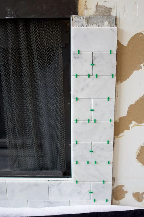 Adding marble subway tile to a fireplace surround. Our fireplace makeover is coming along! We added marble subway tile to the hearth and fireplace surround for a classic and clean look. Here's how to tile a fireplace and the pre-mixed grout that was such a gamechanger! #tile #marbletile #marblesubwaytile #DIYfireplace #tilefireplace #DIY #howto #tutorial How To Tile A Fireplace, Marble Tile Fireplace Surround, Marble Tile Fireplace, Subway Tile Fireplace, Tile Around Fireplace, White Stone Tiles, Marble Subway Tile, Fireplace Redo, Fireplace Update