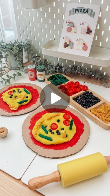 Engaging Elodie on Instagram: "Elodie loved our pizza mud kitchen a few weeks ago so this week I reused the ‘pizza bases’ for an indoors activity! 🍕  The cheese is home made playdough (message me if you want the recipe)! And all the toppings are pasta/chickpeas covered in paint.   A lovely activity for developing fine motors skills and creative/imaginary play. 🍕💛  #playdoughplayactivities #sensoryplay #messyplay #toddleractivities #reelsdaily #finemotorskills #prewritingskills #creativeplay #learningthroughplay #toddlerdevelopment #playbasedlearning #homeeducation" Playdough Ideas For Kids, Pizza Activities For Kids, Pizza Playdough, Home Made Playdough, Indoor Activities For Preschoolers, Gf Dough, Playdough Activities Preschool, Pasta Chickpeas, Play Dough Ideas