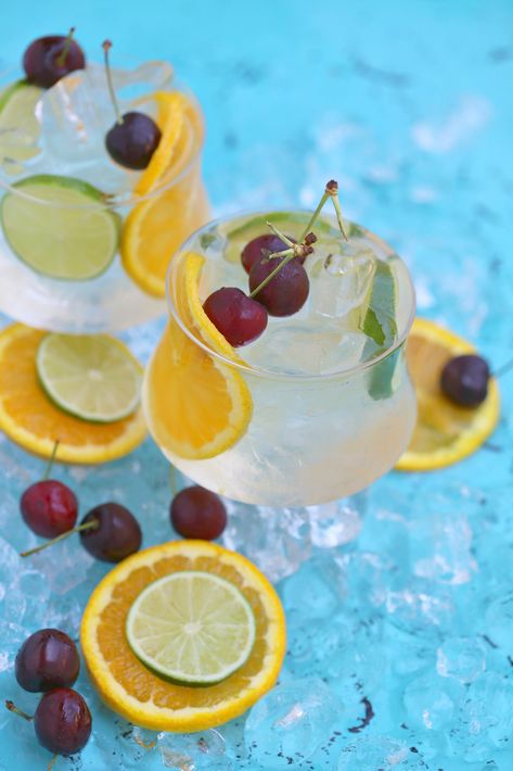 Coconut Citrus Sangria - Today I want to share with you a refreshing tropical sangria made with white wine, coconut water, citrus, fresh cherries and sparkling orangeade all items I picked up on my latest visit to Sprouts. I simply add everything to my pitcher, place in the fridge to chill & allow flavors to meld while I frantically clean my living room (pre-sangria work-out, LOL) and I’m all set to entertain. Tropical Sangria, Citrus Sangria, Fall Sangria Recipes, Deep Fried Pickles, Sangria Cocktail, White Wine Sangria, Cocktail And Mocktail, Fried Pickles, Festive Cocktails