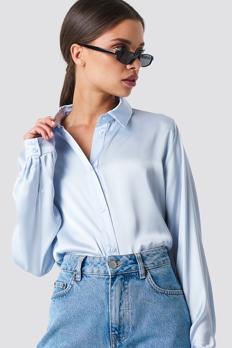 The Long Sleeve Satin Shirt by NA-KD Classic features a collared neckline, buttons down the front, two buttons at each cuff, a wide fit, and smooth silk material. Blue Satin Shirt Outfit, Blue Shirt Outfit, Satin Shirt Outfit, Stylish Knitwear, Capsule Closet, Satin Blouses, Satin Shirt, Satin Blouse, Silk Material