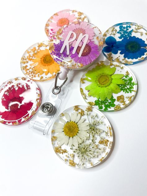 Are you a nurse who loves floral? 🌸 These floral badge reels are so pretty and filled with real pressed flowers of your choice!  Choose from a variety of colours!  Each reel measures - 4cm's x 4cm's and comes with a strong slide backing to attach to your attire!  Choose to have your name or job title on the front which will be then sealed with a layer of resin over the top!  If you have any questions please reach out! 🙂 Thank you very much! - Amelin x Resin Badge Reel Ideas, Nurse Name Badge, Resin Ideas, Name Badges, Feb 2, Post Ideas, Job Title, Floral Color, Nurse Life