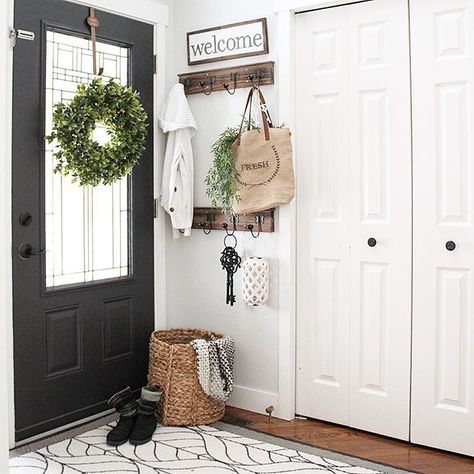 Hello everyone! Wanted to quickly share a shot of our front entry way. We made only a few small changes here, but they made a huge impact. I painted the interior part of the door from white to Wrought Iron by #benjaminmoore (my fave interior door colour ) then we replaced all the 2" orange oak trim with flat white trim, and then added these simple hooks behind the door for backpacks and bags, and that's it! This was a small budget friendly makeover that's made such a huge difference in her Interior Door Color, Rustic Farmhouse Entryway, Modern Farmhouse Entryway, Farmhouse Entryway, Foyer Decorating, Entry Way Design, Front Entry Doors, Small Entryway, Entrance Decor