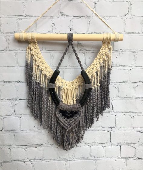 DESCRIPTION • This hand dyed, charcoal grey beauty has an ombre effect on 100% cotton rope. A genuine horseshoe with felted detail adds texture to this fun, one of a boho western wall hanging. Perfect for any bedroom or living space. MATERIALS • Hand Dyed 100% Cotton Rope • Wooden Dowel • Painted Macrame Dip Dye, Diy Wall Hanging Yarn, Horseshoe Crafts Projects, Macrame Wall Hanger, Macrame Headboard, Western Crafts, Fiber Wall Art, Black Macrame, Horseshoe Crafts