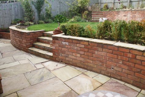 Brick Wall Landscape Ideas, Small Courtyard Garden Ideas Brick Walls, Concrete Patio Between House And Garage, Brick Wall Capping Ideas, Low Brick Wall Front Yard, Small Brick Wall Garden, Curved Garden Wall, Brick Wall Garden Ideas, Backyard Brick Wall Ideas