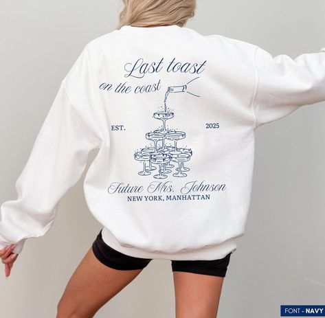 Take any special event to the next level with this exclusive Champagne-themed Sweatshirt. Carefully crafted from premium cotton, this sweater offers a perfect blend of comfort and standout style. Whether it's a bachelorette party, birthday bash, or any other occasion, this shirt makes the perfect gift for everyone involved. Let's celebrate in style!🥂 Note 👉🏼 You can expect a draft of your custom print within 24 hours for your review and approval. Please keep an eye out for a message! ITEM DETAILS * * Crewneck Sweatshirt, 50% cotton, 50% polyester * Unisex Sizing: S, M, L, XL, 2XL, 3XL, 4XL, 5XL * Model is 5'8, Wearing XL in photos *  Runs true to size, order 1-2 sizes up for an oversized fit Take a look at the photos to see a specific sizing chart for this shirt style. Please note that New York Bachelorette, Champagne Bridal Party, Bachelorette Sweatshirts, Bachelorette Merch, Luxury New York, Luxury Bachelorette, Last Toast On The Coast, Toast On The Coast, Sparkle Gift