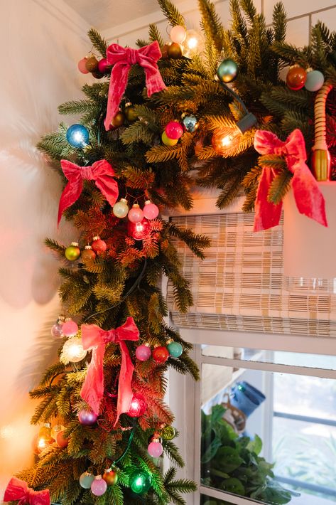 Kitchen Christmas Garland with Ribbon - Blushing Bungalow | So Cute You'll Blush ☺️ Colored Lights On Christmas Tree, Christmas Decor Bright Colors, Retro Christmas Garland, Pink Retro Christmas Aesthetic, Over The Top Christmas Tree, Christmas Tinsel Garland Ideas, Multi Color Lights Christmas Tree Ideas, Christmas 90s Aesthetic, Christmas Garland With Ribbon