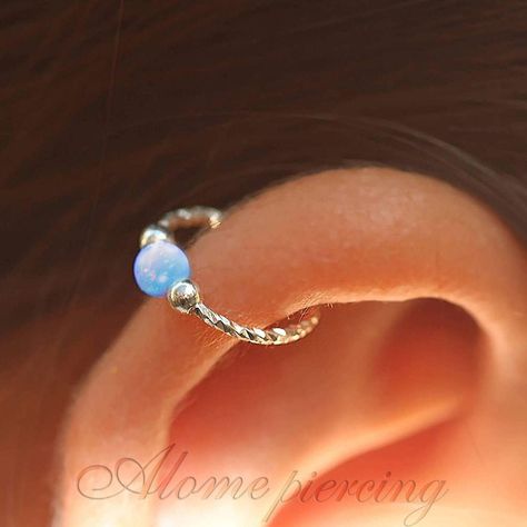 Sterling Silver Blue Opal Cartilage Earring ♥ Handmade 925 Sterling Silver hoop with 3mm dazzling Blue opal cartilage earring, can be used as helix hoop, helix hoop earring, Nose hoop, Cartilage earring. ♥ It is handmade out of 925 Sterling Silver Soft wire. ♥ The Size is 8 mm in Diameter, 20 Gauge with 3 mm Blue opal. ♥ Comfortable, lightweight, and easy to use, it is the most common size for cartilage earrings, please make sure it is the right size for you. ♥ Also Available In 3 additional Opal bead colors - pink, green, and white, please visit my shop. Measurements: ♥ Size Available: 0.3Inch - 8 mm Hoop Diameter. ♥ Gauge (Thickness of the wire): 0.8mm - 20 gauge Note: To put it on please twist the hoop sideways and slide it in, after it is in close it back and align it (instruction insi Blue Piercings Ear, Silver Helix Earrings, Helix Piercing Ring, Hoop Cartilage Earrings, Helix Hoop Earring, Opal Cartilage Earring, Helix Earrings Hoop, Helix Piercing Jewelry, Helix Hoop