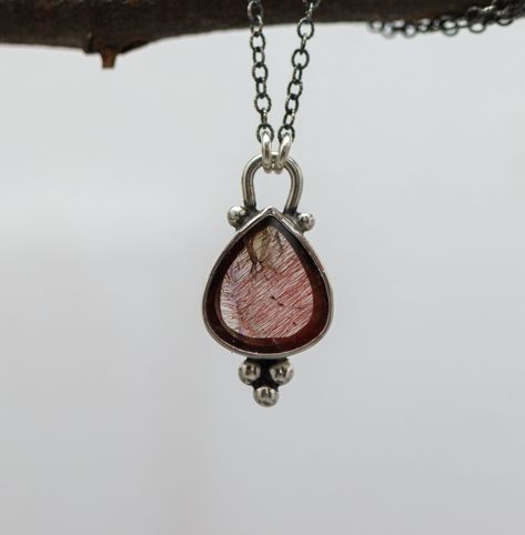 This necklace features a super seven gemstone, also called Melody Stone. It is a rare stone that is comprised of seven different minerals, Amethyst, Cacoxenite, Geothite, Lepidocrocite, Rutile, Smoky Quartz, and Quartz. This stone has become very hard to find lately and I have just found out that is because it is only found in one mine in the world and that mine is flooded out and completely underwater. So who knows if they will ever be able to get back in there ever again. I have set this simply with an open back to let light through. Pendant is 1 inch long and 1/2 inch wide. ♦Chain: Choose from drop down. Will come on oxidized cable link chain with 2 inch extension chain. So if you order 16 inches it will be adjustable from 16-18, 18 inches will be adjustable from 18-20 and so on. ♦ Meta Sterling Silver Gemstone Necklace, Rare Stone, Stone Pendant, Silver Pendant Necklace, Smoky Quartz, Fine Silver, Ring Bracelet, Stone Pendants, Gemstone Necklace