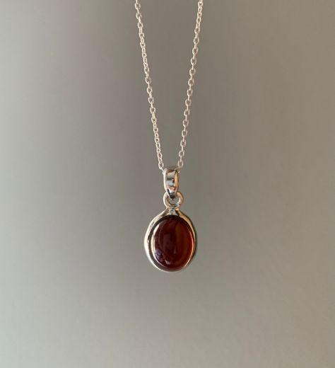 Sterling silver garnet necklace. This beautiful deep red garnet comes in a circular shape and set in an elegant silver design. Garnet is a deeply spiritual stone that inspires love and devotion. It comes on an 18 inch silver chain. Crystal Necklaces, Garnet Necklace, Dope Jewelry, Silver Design, Funky Jewelry, Jewelry Lookbook, Necklace Boho, Circle Necklace, Jewelry Inspo