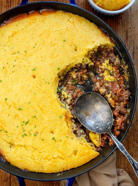 Cornbread Cowboy Casserole is made with a cowboy baked bean and ground beef base, and a delicious cheesy cornbread topping. Cowboy Casserole, Casserole Recipes, Cornbread Casserole, Cornbread Meat Casserole, Dinner, Supper, Campfire Recipes, Camping Recipes, Dinner Recipes, Hearty Dinner Recipe, i am homesteader, iamhomesteader Cast Iron Cowboy Casserole, Recipes To Go With Cornbread, Cornbread Skillet Casserole, Homemade Cornbread Casserole, What To Eat Cornbread With, Cowboy Skillet Casserole, Cowboy Dinner Ideas, Main Dishes For Dinner Beef, Southern Cornbread Casserole