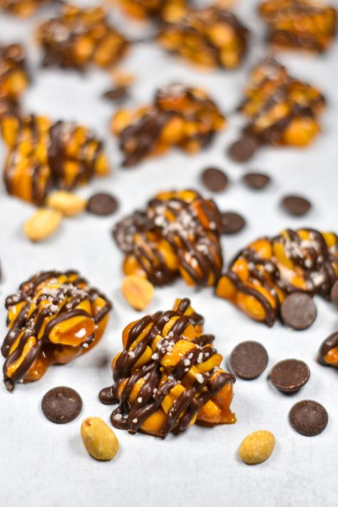 A sweet and simple peanut cluster recipe. Crunchy peanuts, drizzled in dark chocolate and sprinkled with just a touch of sea salt. Peanut Cluster, Chocolate Peanut Clusters, Peanut Clusters, Cooking For One, Silicone Baking Mat, Roasted Peanuts, Baking Mat, Chocolate Peanuts, Corn Syrup