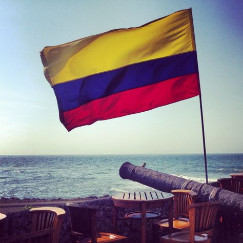 Colombian Flag flying over the walls of the old city Colombian Flag Aesthetic, Colombia Flag Aesthetic, Columbian Flag, Flag Aesthetic, Colombian Flag, Catholic Aesthetic, Colombia Flag, Colombian Culture, Flag Outfit