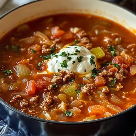 This Hearty Beef and Cabbage Soup is a comforting and flavorful dish that’s perfect for chilly days. Loaded with lean ground beef, tender vegetables, and a tomato-based broth, this soup brings warmth and satisfaction to the table. It’s easy to make, filling, and ideal for those who love simple yet hearty meals. Plus, the combination of cabbage and carrots gives it a nutritious boost, making it a great addition to your weekly menu! Preparation Time: 15 minutes Cooking Time: 35 minutes Total Time: Beef And Cabbage Soup, Beef Cabbage Soup, Cabbage And Carrots, Cabbage Stew, Hearty Vegetable Soup, Cabbage Roll Soup, Soup With Ground Beef, Beef And Cabbage, Tofu Scramble