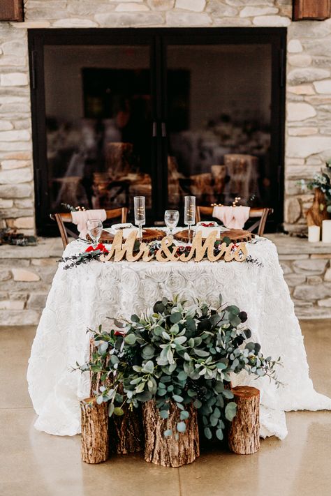 Wood stump arrangement with greenery in front of head table, gold Mr. and Mrs. signs, ivory rosette tablecloth, fireplace head table  Venue: The Sycamore Winery Photography: Kayla Lynn Creative Floral: Cowan & Cook Food: Edibles Catering Small Head Table Wedding, Front Of Head Table Decor, Inside Wedding Arch, Wedding Party Head Table Decor, Mr Mrs Sign Wedding Head Tables, Wedding Reception Bride And Groom Table, Mr And Mrs Table Decoration, Me And Mrs Table, Mr And Mrs Table Wedding