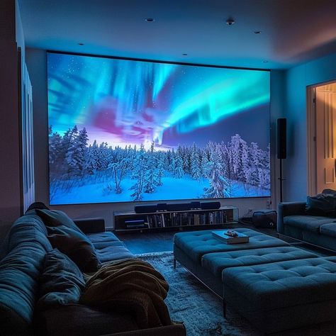 Cozy home theater room with northern lights projection screen, snow-covered forest, ambient blue lighting, and leather sofas. Perfect for movie nights and enhancing home decor. Room Movie Projector Aesthetic, Movie Room With Projector, Modern Theater Room Design, Movie Theater Rooms Aesthetic, Big Tv Living Room, Modern Theater Room, Indoor Cinema, Chalet Ideas, Plan Movie