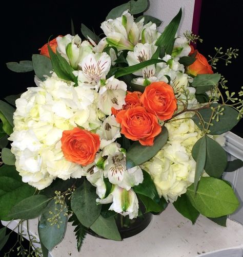 Orange and white round table centerpiece with white hydrangea, orange spray roses, alstroemeria and seeded eucalyptus in square glass vase. $59. Hydrangea Orange, Round Table Centerpiece, White Hydrangea Centerpieces, White Round Table, Square Glass Vase, White Round Tables, Baked Falafel, White Flower Arrangements, Hydrangea Centerpiece