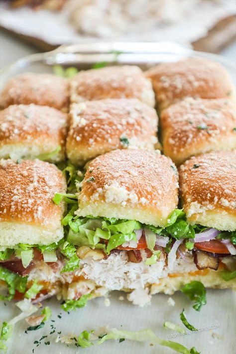 Feed a crowd with these easy turkey club sliders! Sweet Hawaiian rolls layered with turkey, smoky bacon, cheese, juicy tomatoes, and fresh lettuce make these sandwich-style sliders so good. Best of all, they’re really easy to make, simple enough for an easy family meal but also scalable to feed a crowd. Level up your slider game with these fun and fresh turkey sliders! Turkey Sandwiches For A Crowd, Turkey Sliders Recipes, Turkey Sandwich Sliders, Turkey Club Sliders, Club Sliders, Crowd Meals, Sliders Recipes Turkey, Sweet Hawaiian Rolls, Luncheon Recipes