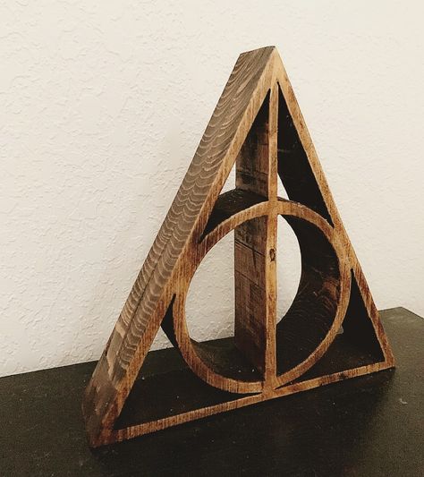 Deathly Hallows cut out on my scroll saw from 2-1x8’s glued together! Super simple and an awesome little gift for all those PottHeads out there! Diy Harry Potter Wood Projects, Harry Potter Wood Projects, Diy Deathly Hallows, Harry Potter Wood Cutout, Zelda Wood Projects, Harry Potter Wood Signs, Deathly Hallows Symbol, Casual Home Decor, Wedding Renewal Vows