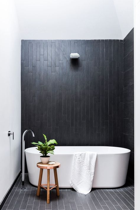 A lightwell illuminates moody charcoal ceramics. “At night, LED strip lighting makes the water from the rainshower glisten,” says Carlo. Forme bath, [Harvey Norman](http://www.harveynorman.com.au/?utm_campaign=supplier/|target="_blank"). Ellisse tap, [Parisi](http://www.parisi.com.au/?utm_campaign=supplier/|target="_blank"). Tiles, [Skheme](http://www.skheme.com/?utm_campaign=supplier/|target="_blank"). Stool, [Koskela](http://www.koskela.com.au/?utm_campaign=supplier/|target="_blank"). Towe... Timeless Bathroom Design, Monochrome Bathroom, Black White Bathrooms, Beautiful Bathroom Designs, Timeless Bathroom, Minimal Interior Design, Bad Inspiration, Trendy Bathroom, Minimalism Interior