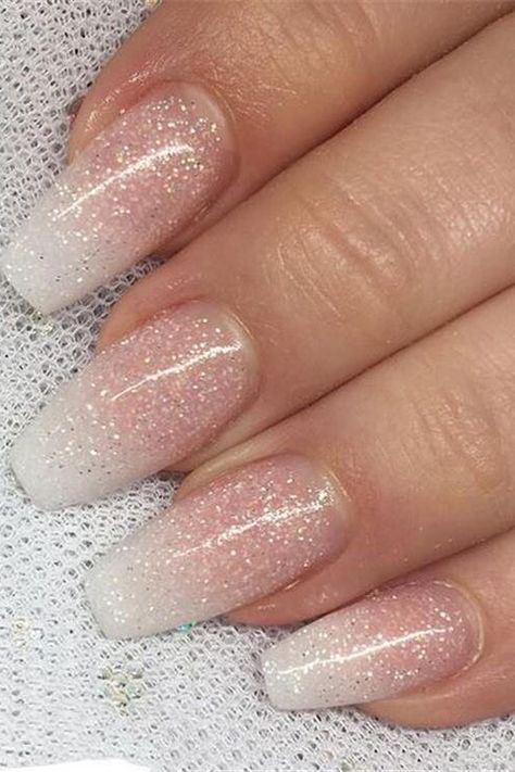 These almond-shaped nails shimmer with a delicate grace, featuring a sheer pink base that graduates into a dusting of white glitter towards the tips. The subtle sparkle creates a snow-kissed effect, perfect for a refined yet enchanting winter look. Simply elegant! ❄️✨  // Photo Credit: Instagram @_nailsmade Pink Graduation Nails, White Glitter Nail Designs, Subtle Glitter Nails, Ireland Nails, Demure Nails, Wedding Nails Pink Glitter, Leavers Party, 2025 Aesthetic, Nails Shimmer