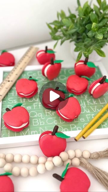 Baked by Joyce on Instagram: "🍎Apple Macarons🍎 These apple macarons were a part of the dessert boxes I made for Teacher Appreciation Week. 🍎🌼🧁 It’s my first time piping apples but I have to say, it’s pretty easy to pipe! These apple macarons are filled with vanilla buttercream and Nutella. 🍫🌰 The stem is made from a gluten free pretzel stick dipped in dark chocolate. 🍫🥨 The fondant leaf was then attached to the apple with a little bit of red candy melts. 🍃 Products used: - @bakell fondant - @sweetshopbaking melt’ems in red - @ghirardelli dark chocolate melting wafers - @thesugarart Master Elite powder in red - @bluediamond almond flour You can find some of these products plus other items I use to make desserts on my Amazon Storefront. 🛒 Link on my profile! #macaron #macarons #fr Apple Macarons, Fondant Leaves, Chocolate Melting, Gluten Free Pretzels, Chocolate Melting Wafers, Pretzel Sticks, Dessert Boxes, Cookie Tutorials, Cookie Do