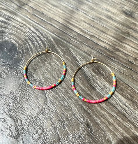 ~ Details ~ These boho style earrings are great for everyday, work, casual or just for a fun pop of color !  Bright pink, turquoise and matte gold colored glass seed beads. 1.25" inches in diameter in matte gold lightweight hoops (lead and nickel free plating over brass) ~ listing is for 1 pair of earrings ~ Join me on Instagram: www.instagram.com/therubyleo Join me on Facebook: www.facebook.com/therubyleo Join me on Pinterest: www.pinterest.com/therubyleo Boho Style Earrings, Beaded Hoops, Seed Bead Earrings, Matte Gold, Bead Designs, Jewelry Earrings Hoops, Bright Pink, Boho Earrings, Beaded Earrings