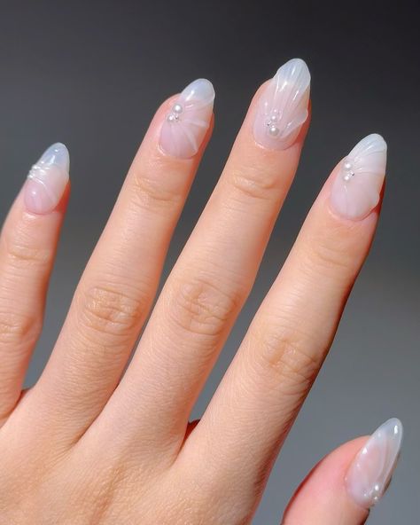 🤍Pearl Shells - 🐚 These premium handmade press-on nails feature a translucent white base with elegant 3D shell-like designs, accented by small pearls for a sophisticated and ethereal look. #nomoodnails #3dnailart #handmadenails #pressons #whitenails #shortnails Pearl Nail Designs, White Sparkly Nails, Pearl Nail, Pearl Nails, Sparkly Nails, 3d Nail Art, Pearl Shell, Nude Nails, White Nails