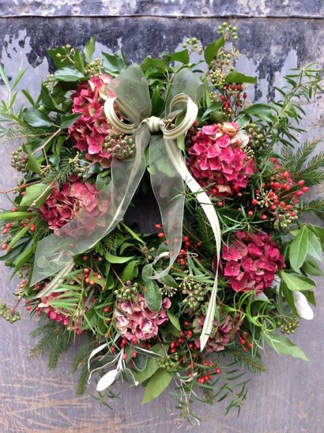 While wreaths are most commonly associated with seasonal foliage, berries and pine cones, flowers are a great way to add colour and vibrancy and give the look a contemporary twist. We love this floral wreath, which teams laurel and eucalyptus leaves with delicate pink hydrangea and deep red velveteen celosia. Raindrops And Roses, Easter Spring Wreath, Natural Wreath, Christmas Door Wreaths, Hydrangea Wreath, Wreaths And Garlands, Xmas Wreaths, Garden Gate, Christmas Flowers