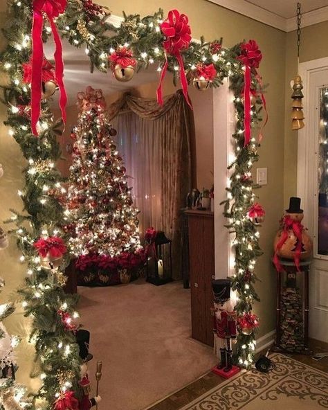 Create a warm and magical holiday entrance with this beautifully decorated Christmas archway. Adorned with lush greenery, vibrant red bows, and sparkling lights, it frames the doorway perfectly and guides guests toward the glowing Christmas tree in the living room. The addition of nutcrackers and traditional holiday decor completes the cozy, classic Christmas vibe. Christmas Diy Party, Christmas Archway, Decorations Christmas Diy, Diy Christmas Party, Traditional Holiday Decor, Christmas Vibe, Simple Christmas Decor, Sparkling Lights, Diy Christmas Decorations