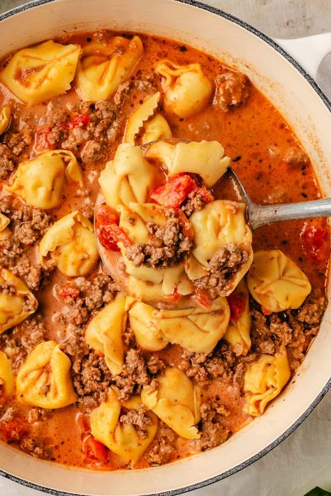 A tasty, creamy Beef Tortellini Soup recipe that the whole family will love. Made with ground beef, diced tomatoes, onions, beef broth, cream, and tortellini. This flavorful soup is the perfect for chilly days or when you're craving something comforting and hearty. Slow cooker option included. Creamy Beef Tortellini, Beef Tortellini Soup, Beef Broth Soup Recipes, Ground Beef Diced Tomatoes, Tortellini Soup Crockpot, Soup With Beef Broth, Beef Tortellini, Crock Pot Tortellini, Cheese Tortellini Soup