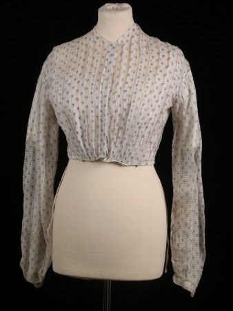 Ca. early to mid-1860s. Extremely sheer barred white muslin bodice and skirt printed with mauve and black sprig. Bodice has vertical tucks front and back. Bishop sleeves, narrow cuffs. Inner bodice of white cotton trimmed with broderie Anglaise. Would most likely have been basted together for wear. Killerton Fashion Collection, National Trust. [jrb] 1860s Dresses, Sheer Dresses, Victoria Reign, Reference Ideas, Historical Costuming, Period Piece, Dress Bodice, Victorian Ladies, Hoop Skirt