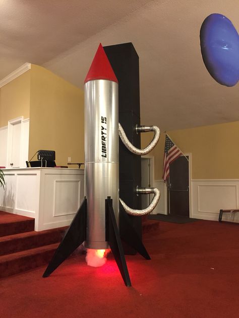 Rocket and Tower we made for VBS 2015.  Rocket is sheet metal with fog machine and red light.  Rocket is attached to a sheet metal tower connected with metal flexible hose. Outer Space Props Diy, Vbs Rocket Ship, Rocket Ship Out Of Boxes, Rocket Photo Booth, Space Rocket Diy Cardboard Boxes, Rocket Ship Dramatic Play Outer Space, Rocket Decorations, Mission Space, Space Theme Classroom