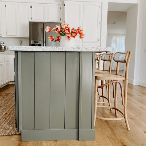 One of my favorite parts of our house is the green shiplap on our island. We had the cabinets painted white, but chose the color Eclipse from sherwinwilliams for the island. It is a soothing shade and really helps to ground the space! Swipe through to see our kitchen’s transformation! Wood Feature Kitchen Island, Green Shiplap Island Kitchen, Center Island Color Ideas, Beige Cabinets Green Island, Kitchens With Contrasting Islands, Painted Shiplap Island Kitchen, Kitchen Island Vertical Shiplap, White Kitchen Cabinets With Color Island, White Kitchen Cabinets With Colored Island