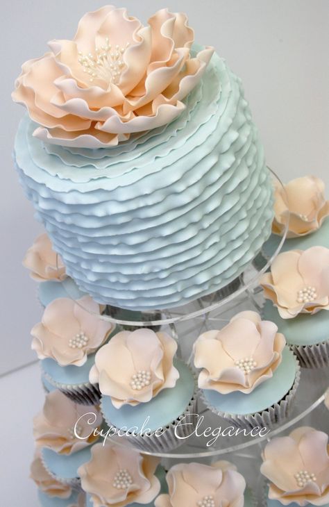 Really like the top of this, not sure about the big flower though Blue And Peach Cupcakes, Gorgeous Cupcakes, Wedding Cakes And Cupcakes, Wedding Bonbonniere, Peach Cupcakes, Cupcake Stand Wedding, Unique Cupcakes, Small Wedding Cakes, Blue Cakes