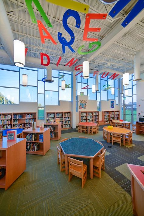 The Mineola UFSD approached H2M with the idea of creating a new, state-of-the-art library addition suited to the Pre-K through second students attending it's Hampton Street Elementary School. The new building is a modern approach to library science, with an integrated library/media center. The space incorporates cheerful colors, small furniture, and expansive windows to allow natural light to flood the space. School Library Design, Preschool Designs, Science Design, Library Media Center, Elementary School Library, Community Library, Elementary Library, School Interior, Library Furniture