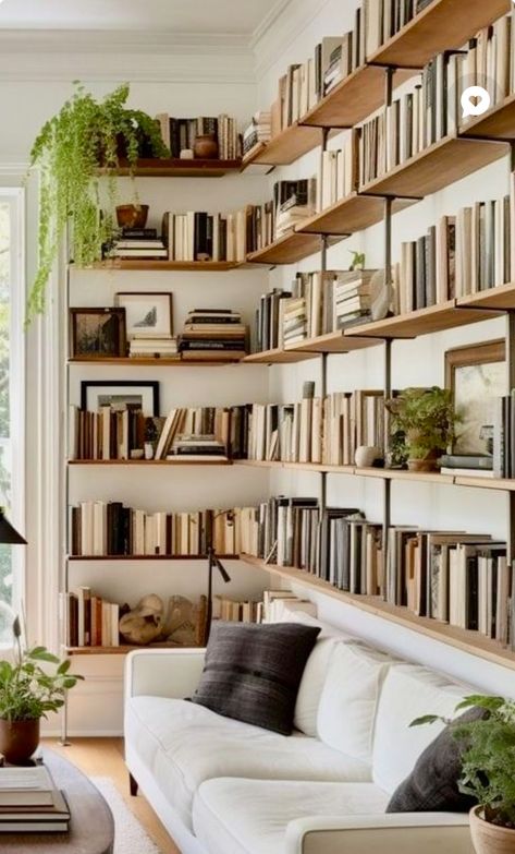 Bookshelves Above Sofa, Bookcase Above Sofa, Couch In Front Of Bookshelves, Floating Shelf Library, Guest Room Library Combo, Home Mini Library, Floating Bookshelves Living Room, Modern Library Design Home, Home Library Design Cozy