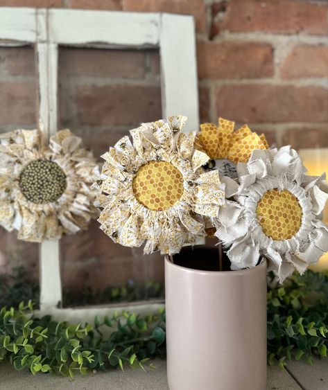 These adorable diy sunflowers are easy and fun to make with scrap fabric. I love the warmth and texture they bring to any space. #diy #sunflower #crafts #crafting #easy #easycraftsforkids #easycraftsideas #home #homemade #homedecorideas #decor #decoration Hot Glue Pot Diy, Mason Jar Lid Flowers, Sunflower Centerpieces Diy, Diy Sunflowers, How To Make Sunflower, Primitive Sunflowers, Farmhouse Flowers, Sunflower Crafts, Making Fabric Flowers