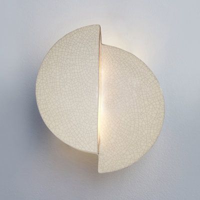 Dynamic minimalism. A flush-mounted wall sconce is a great way to add bold mod style to any room in your home. Two half moon shapes are staggered to create a bold silhouette with internal light that peeks out and scatters throughout your space. It's hand-cast and -textured in ceramic with a variety of hues and patterns to choose from, so you can find just the right look. An integrated, dimmable LED cancels out an extra trip to the hardware store. And it's damp-rated, so it can go in your bathroo Wall Sconces Living Room, Ceramic Wall Lights, Ceramic Lantern, Hammered Iron, Wabi Sabi Wall, Lantern Wall, Mod Style, Ceramic Light, Moon Shapes