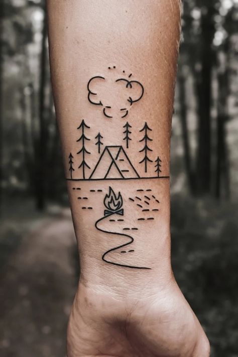 Tattoo of a camping scene with a tent, trees, fire, and clouds on an arm. Small Lake Tattoo Ideas, Camp Tattoo, Small Wrist Tattoo Ideas, Wilderness Tattoo, Outdoor Tattoo, Small Wrist Tattoo, Camping Tattoo, Lake Tattoo, Wrist Tattoo Ideas