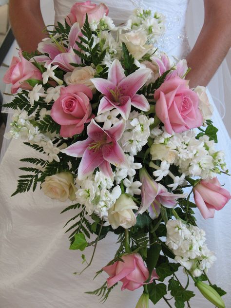 Traditional cascading bouquet of pink stargazer lily, pink sofie rose, white stock, stephanotis Azalea Wedding Bouquet, Pink Roses And Lilies Bouquet, Star Gazer Lily Bouquet Wedding, Stargazer Wedding Bouquet, Pink Lily Bouquet Wedding, Roses And Lily Bouquet, Lilly And Rose Bouquet, Stargazer Lily Bridal Bouquet, Stargazer Lily Wedding Bouquet