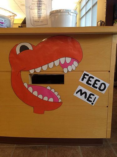 Library book return. YES! I want to have one of these. Could be other things like a hungry hippo too. Library Book Return, Ideas For Bulletin Boards, Dino Activities, Dinosaur Ideas, Book Return, School Library Decor, Library Signage, Board Sayings, Library School