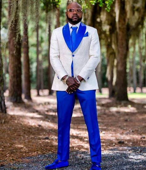 We had the pleasure of clothing another awesome groom for the big day! He rocked down the aisle in a beautifully crafted ivory and royal blue jacquard tuxedo jacket. Contact us to get fitted for your wedding day or any other special occasion and #KeepTheStyleFlowing! White And Blue Tuxedo Wedding, White And Blue Groom Suit, Royal Blue And White Tuxedo, White And Royal Blue Tuxedo, Royal Blue And White Tuxedo Wedding, Royal Blue Wedding Tux Groom, White And Blue Tuxedo, Royal Blue Tuxedo Wedding, Royal Blue Wedding Ideas