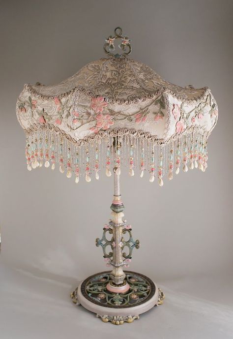 Antique large scale table lamp with flowers has been hand painted and holds an Ivory Carousel silk lampshade. The shade is covered in a luxurious Edwardian era ivory silk satin with silver woven through it. This was from an antique wedding gown and is overlaid around the edge with antique embroidery in pinks and greens. This a a romantic, feminine lamp and lights up beautifully. A jeweled pull chain turns the lamp on and off. Overall height is 32 inches to the top of the finial. The shade is 21 Fancy Lamp, Antique Furniture Victorian, Victorian Shabby Chic, Chandelier Diy, Shabby Chic Table Lamps, Antique Table Lamps, Antique Lamp Shades, Beaded Lamps, Victorian Lamps