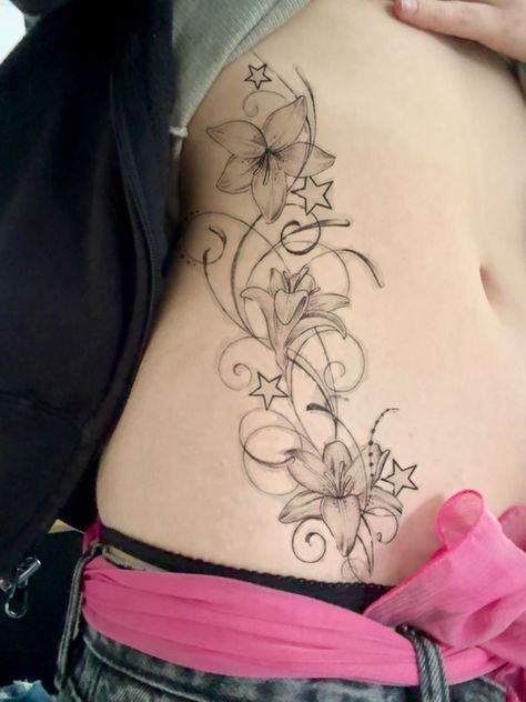 Side Ab Tattoos Women, Whimsical Stomach Tattoo, Flower Tattoo Upper Thigh, Lily Stomach Tattoo, Spine Tattoos Y2k, Neck Nape Tattoo, Hibiscus Tramp Stamp, Y2k Hip Tattoo, Whimsical Tramp Stamp