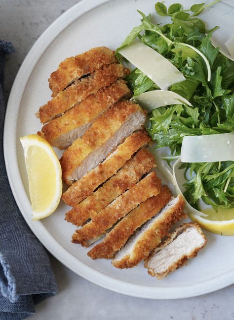 Pork Milanese, or “Cotoletta Alla Milanese“ as it’s often called, is typically made with veal, coated in flour and egg, and dipped in seasoned breadcrumbs, but can be made with other types of meat such as chicken, turkey, or pork. Served with a simple arugula salad, it is a perfect meal all year round but one I love in warmer months. Simple Arugula Salad, Pork Milanese, Milanese Recipe, Pork Cutlets, Panko Bread Crumbs, Arugula Salad, Grated Parmesan Cheese, Arugula, Cooking Time