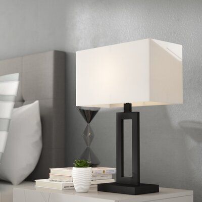 The Larde 20" Table Lamp Collection offers modern styling for any room. Rectangular shape and neutral finish combine to add a stylish modern element to any space. The white linen shade is a classic element that upscales this lamp while the trendy cutout body adds style. The unobtrusive 20-inch size works perfectly in a bedroom, office, or living room and can only enhance any table it sits on. | Latitude Run® Larde 20" Table Lamp Linen/Metal in Black, Size 20.0 H x 14.0 W x 10.0 D in | Wayfair Lamp Collection, Arched Floor Lamp, Fixture Table, Table Metal, Metal Table Lamps, Table Lamp Sets, White Table Lamp, Bedroom Lamps, Modern Lamp