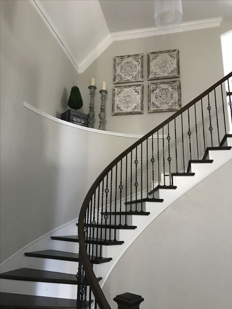 Decorate large high ceiling curved stairs shelf large entryway Curved Stair Wall Decor, Stair Shelf Decor, Staircase Ledge Decor Ideas, High Ceiling Stairway Decor, Curved Staircase Wall Decor, Stair Ledge Decor, Entryway Ledge, Foyer Ledge, Foyer Shelf